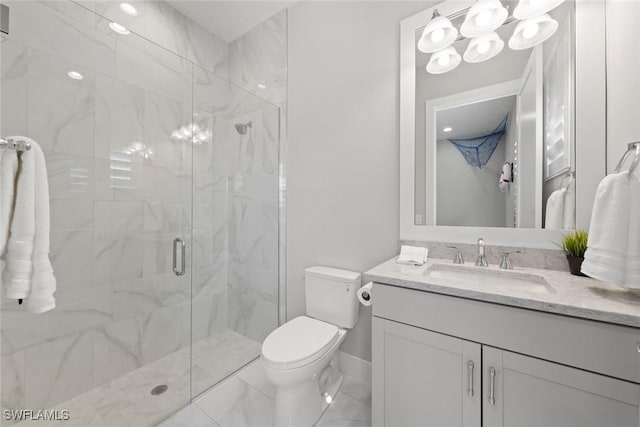 bathroom featuring vanity, an enclosed shower, and toilet