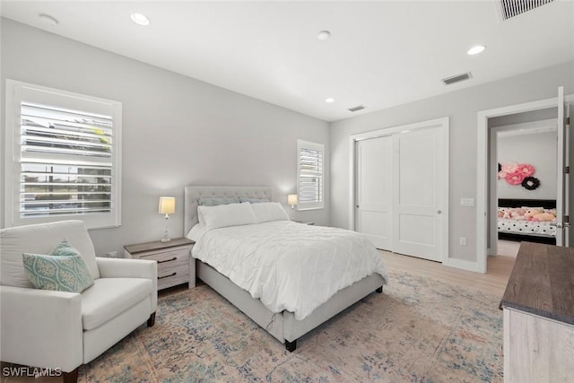 bedroom with a closet and light hardwood / wood-style flooring