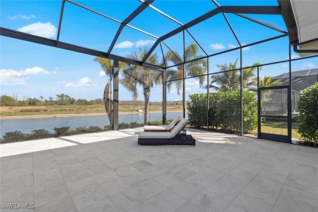 view of patio featuring a water view and a lanai