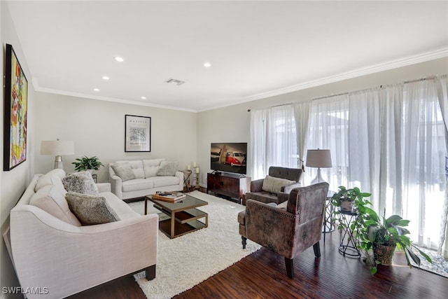 living room featuring crown molding, a healthy amount of sunlight, and dark hardwood / wood-style flooring