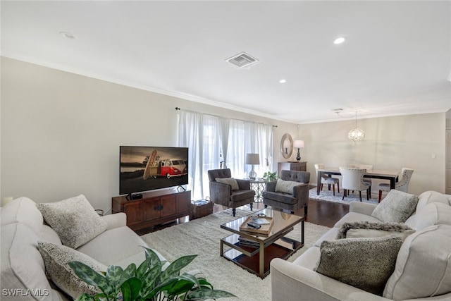 living room featuring hardwood / wood-style flooring and ornamental molding