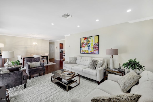 living room with hardwood / wood-style flooring and ornamental molding