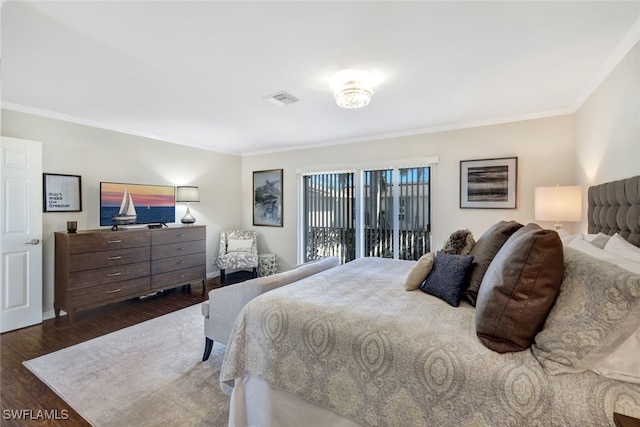 bedroom featuring crown molding and dark wood-type flooring