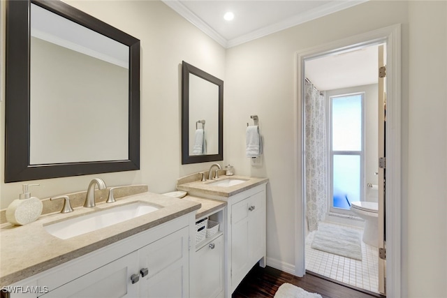 bathroom with wood-type flooring, vanity, crown molding, and toilet