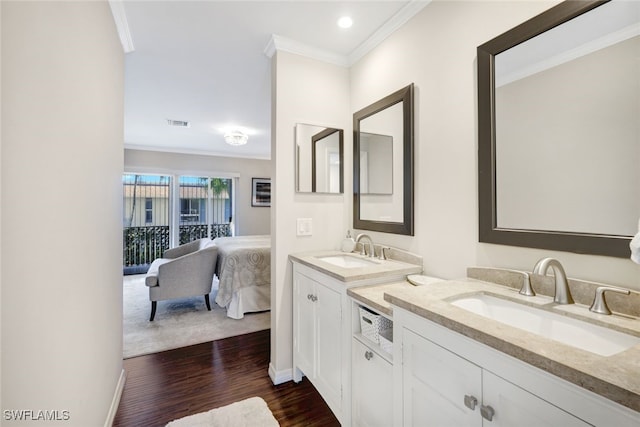 bathroom with crown molding, vanity, and hardwood / wood-style flooring