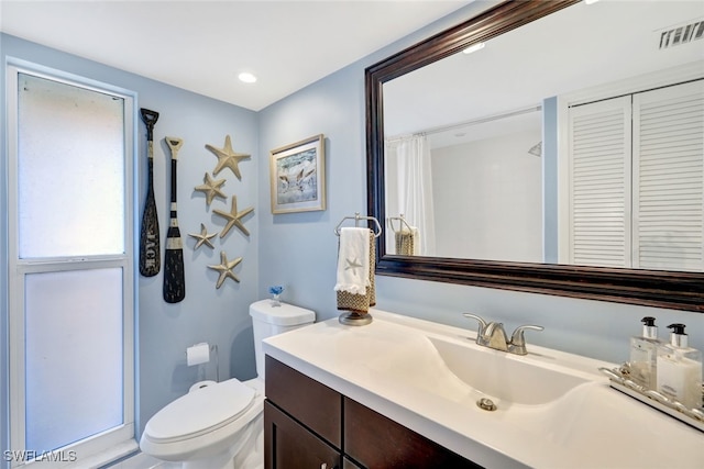 bathroom with vanity and toilet