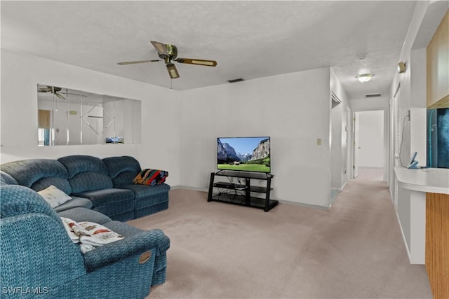 carpeted living room with ceiling fan