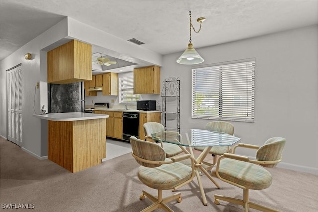 kitchen featuring stainless steel range with electric cooktop, fridge, light colored carpet, kitchen peninsula, and a healthy amount of sunlight