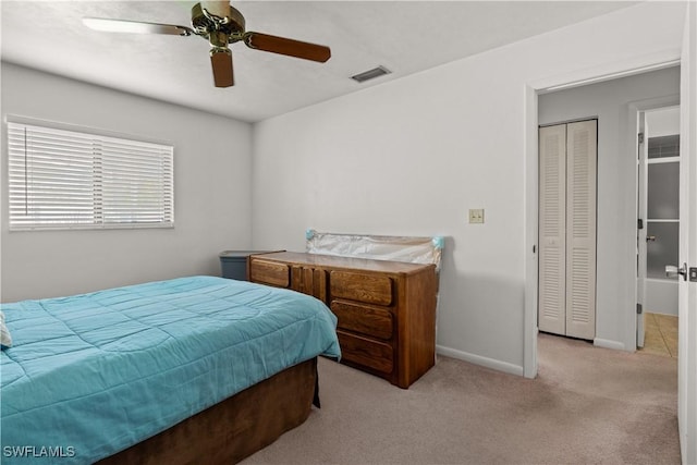 carpeted bedroom with ceiling fan and a closet