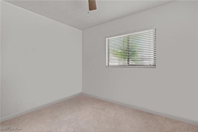 spare room featuring ceiling fan and light colored carpet