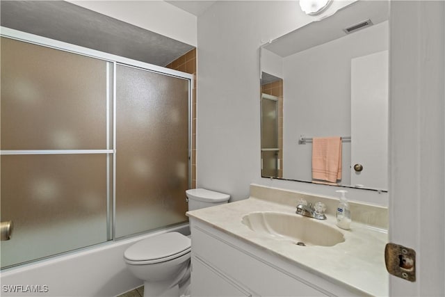 full bathroom with shower / bath combination with glass door, vanity, and toilet