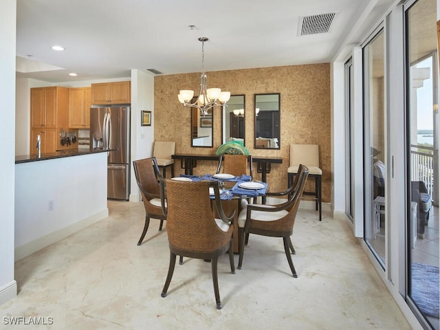 dining space with a chandelier