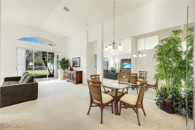 dining room featuring light carpet and high vaulted ceiling