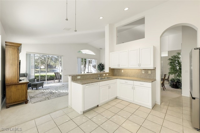 kitchen featuring stainless steel refrigerator, white cabinets, white dishwasher, and kitchen peninsula