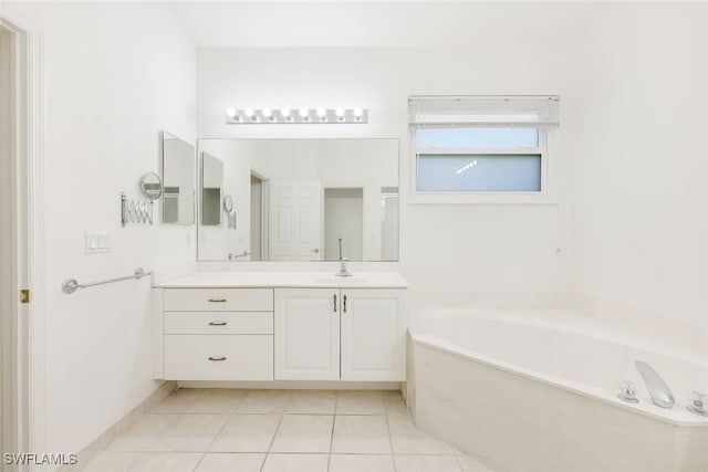 bathroom featuring tile patterned flooring, a bathing tub, and vanity