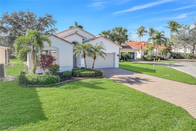 mediterranean / spanish-style home with central AC unit, a garage, and a front lawn