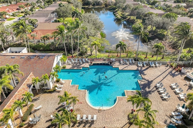 view of pool with a water view and a patio