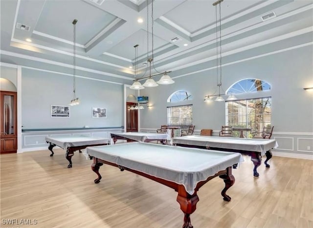 playroom with crown molding, coffered ceiling, and light hardwood / wood-style floors