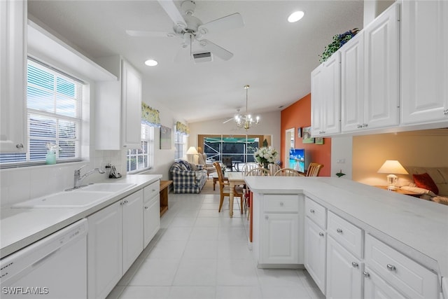 kitchen featuring vaulted ceiling, pendant lighting, sink, white cabinets, and white dishwasher