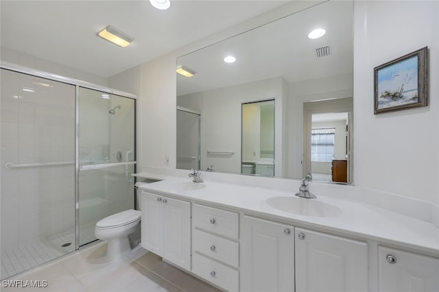 bathroom featuring vanity, toilet, an enclosed shower, and tile patterned flooring