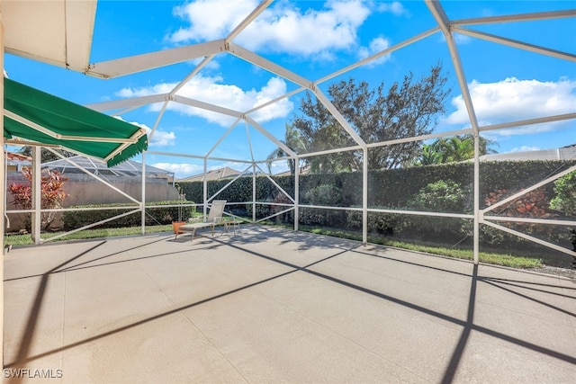 view of patio / terrace featuring glass enclosure