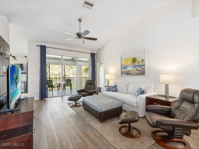 living room featuring ceiling fan, high vaulted ceiling, and light hardwood / wood-style floors