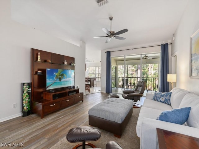 living room featuring hardwood / wood-style flooring and ceiling fan