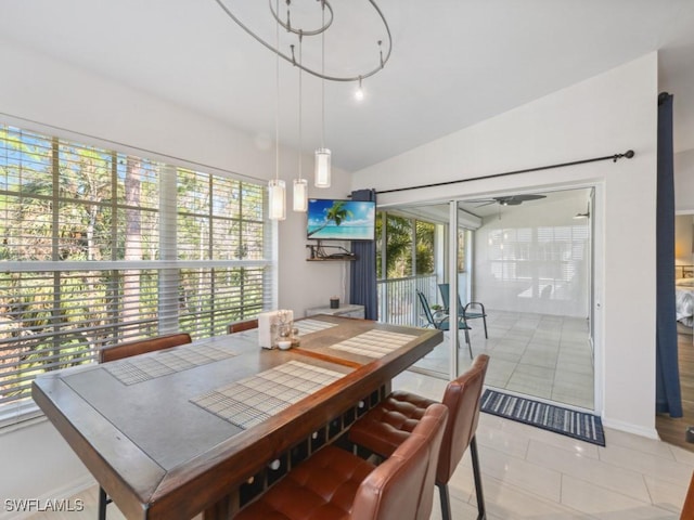 tiled dining room featuring lofted ceiling and ceiling fan