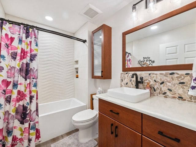 full bathroom with shower / bath combination with curtain, vanity, and toilet