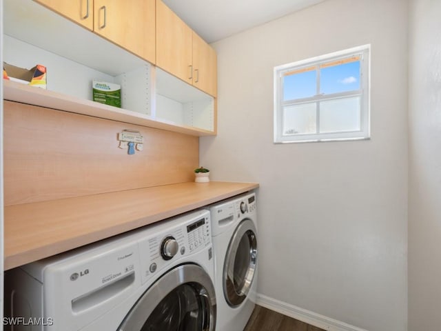 laundry area with separate washer and dryer, dark hardwood / wood-style floors, and cabinets