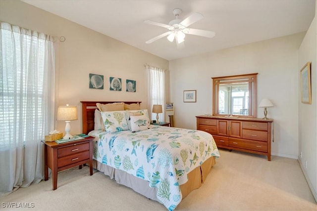 bedroom with ceiling fan and light carpet