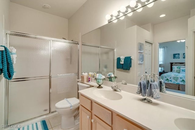 bathroom featuring tile patterned flooring, vanity, toilet, and a shower with shower door