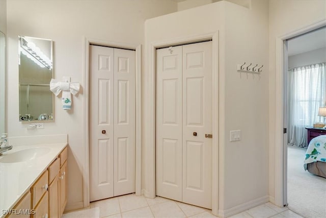 bathroom featuring tile patterned flooring and vanity