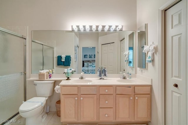 bathroom with a baseboard radiator, vanity, a shower with shower door, tile patterned floors, and toilet