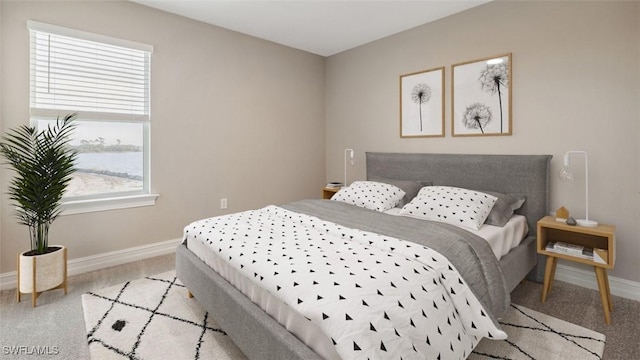 bedroom featuring baseboards and light colored carpet