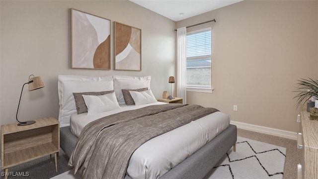 bedroom with light colored carpet and baseboards