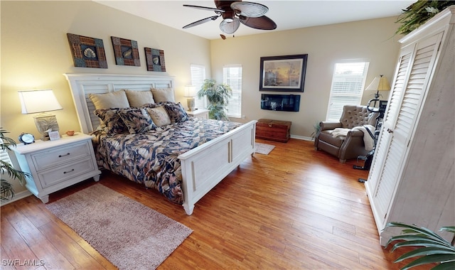 bedroom with ceiling fan and light wood-type flooring