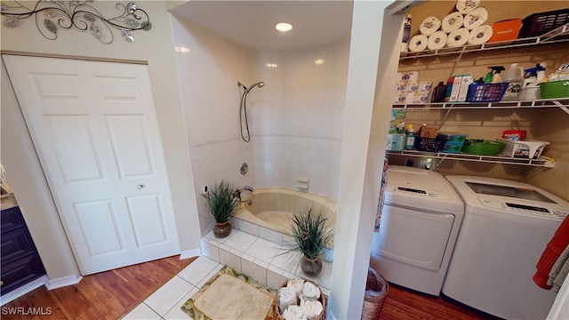 bathroom featuring hardwood / wood-style floors, washer and dryer, and shower / bath combination