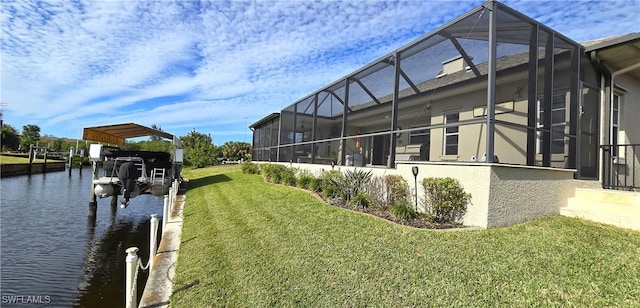 dock area with a water view, a lawn, and a lanai