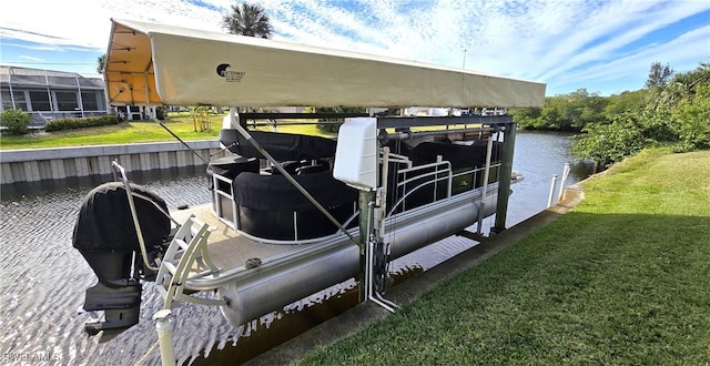 view of dock with a water view and a lawn