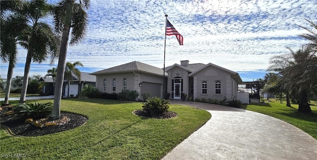 view of front of home with a garage and a front yard