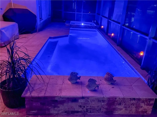 view of swimming pool featuring an in ground hot tub