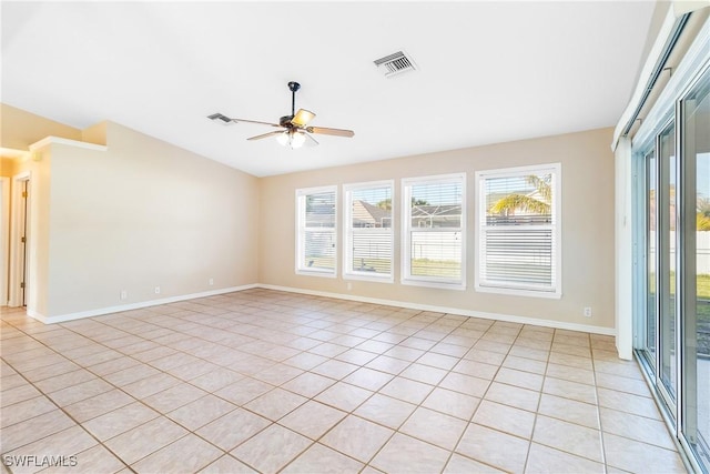 tiled empty room with lofted ceiling and ceiling fan