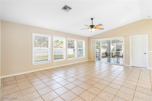 tiled empty room featuring vaulted ceiling and ceiling fan