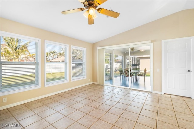 tiled empty room featuring ceiling fan and lofted ceiling