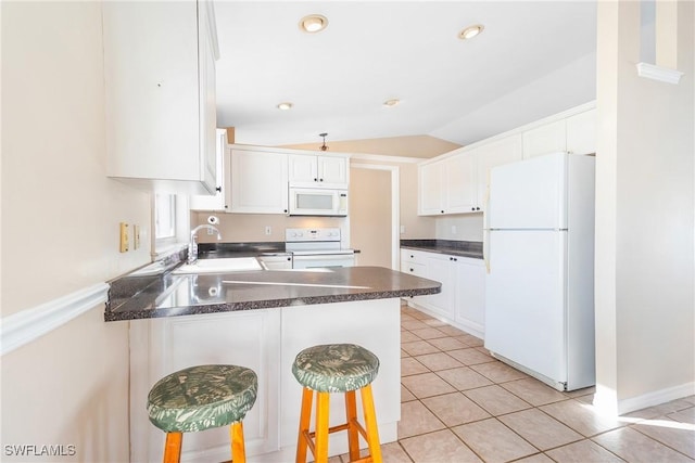 kitchen with sink, white cabinets, a kitchen bar, kitchen peninsula, and white appliances