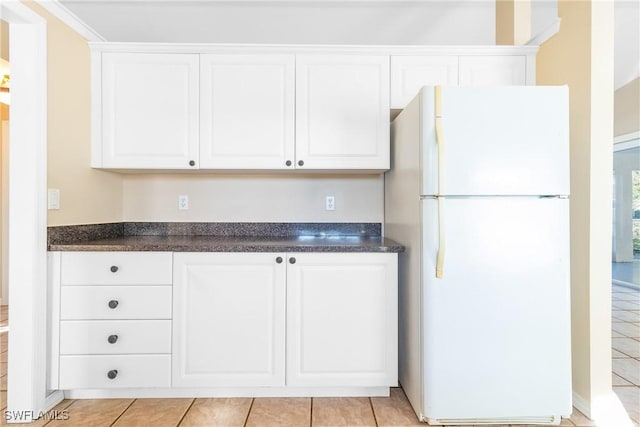 kitchen with white cabinetry and white refrigerator