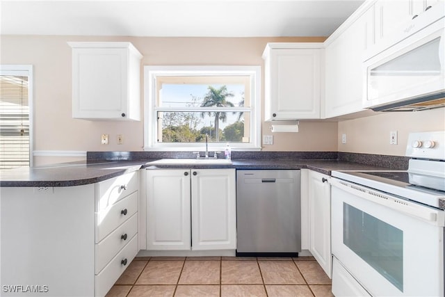 kitchen featuring white appliances, light tile patterned floors, sink, and white cabinets