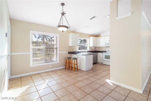 kitchen with light tile patterned flooring, kitchen peninsula, pendant lighting, white appliances, and white cabinets