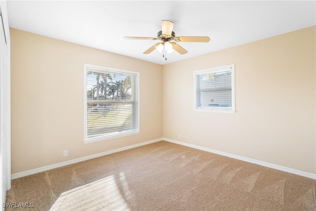 empty room with ceiling fan and carpet floors